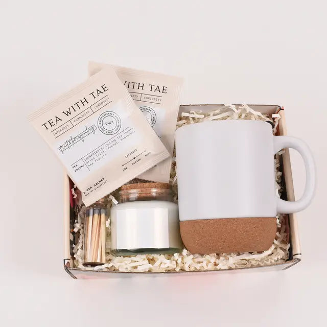 Self-Care & Serenity Gift Box featuring a mug, tea, and candle in a beautifully packaged set.