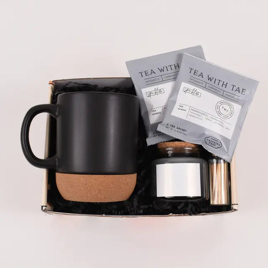 Self-Care & Serenity Gift Box featuring a black mug set and tea packets, beautifully packaged for gifting.