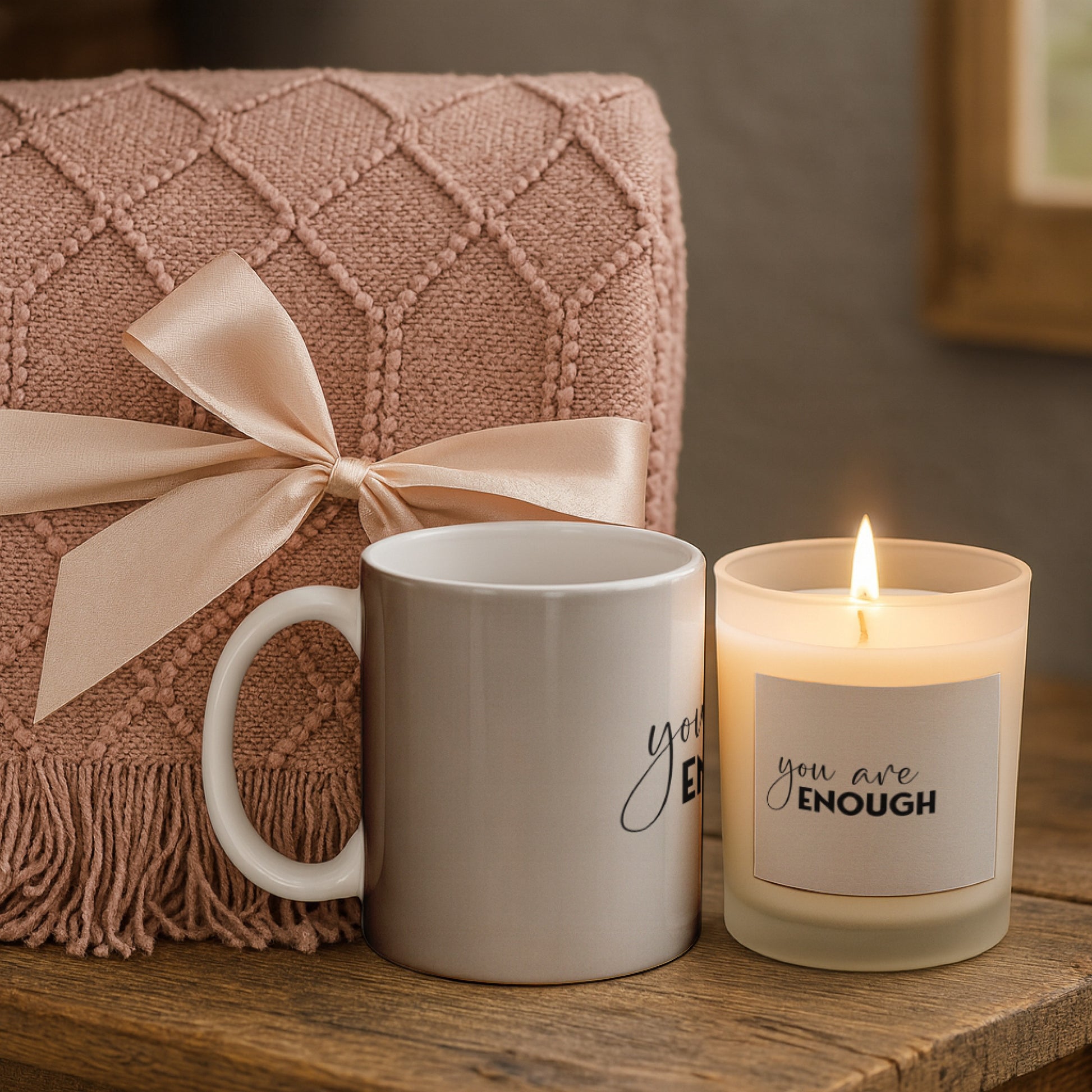 Mental Wellbeing Candle with Mug & Blanket Gift Set featuring a soft pink blanket, a mug, and a lit candle.