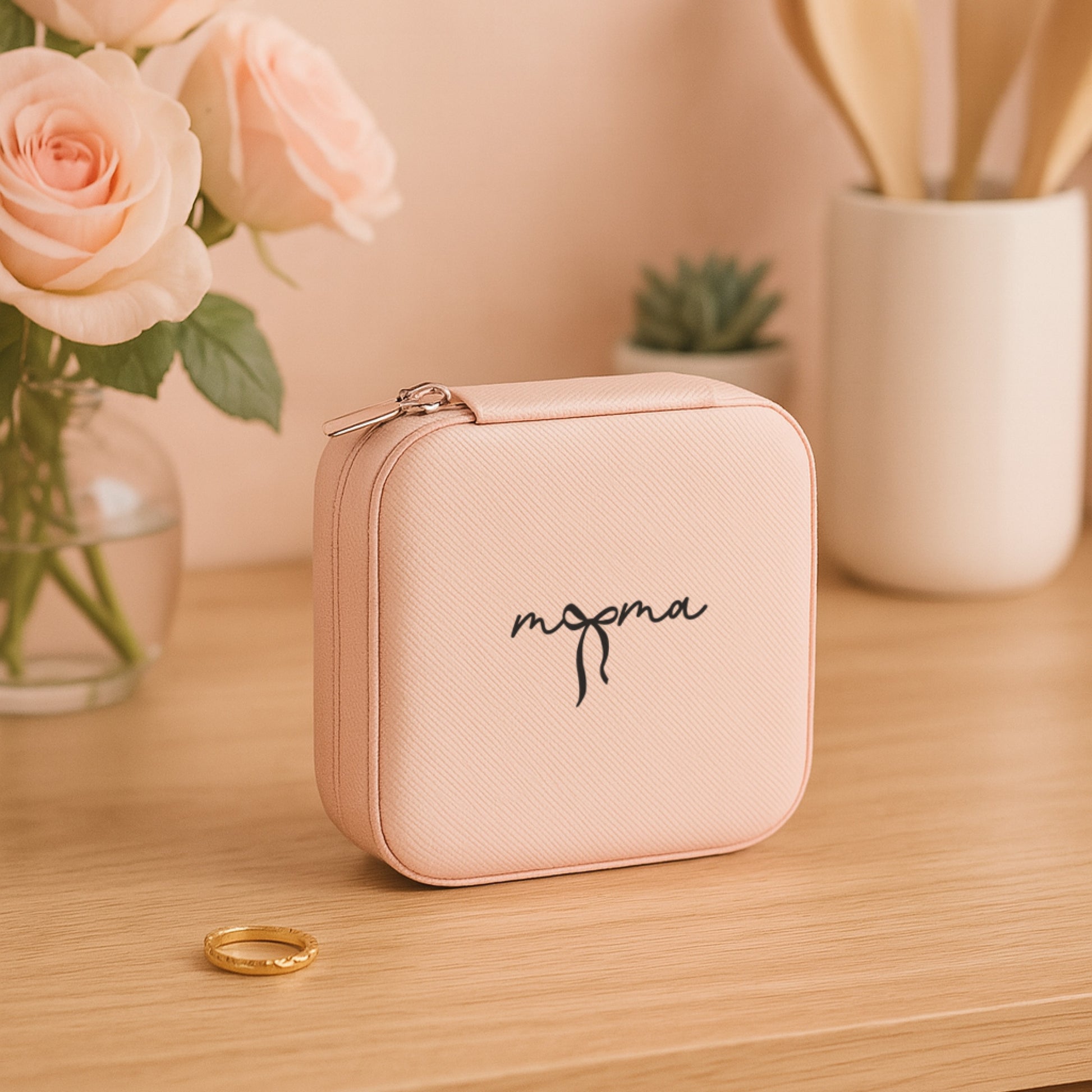 Mama Dream & Wander Gift Set jewelry travel box with roses in the background on a wooden surface.